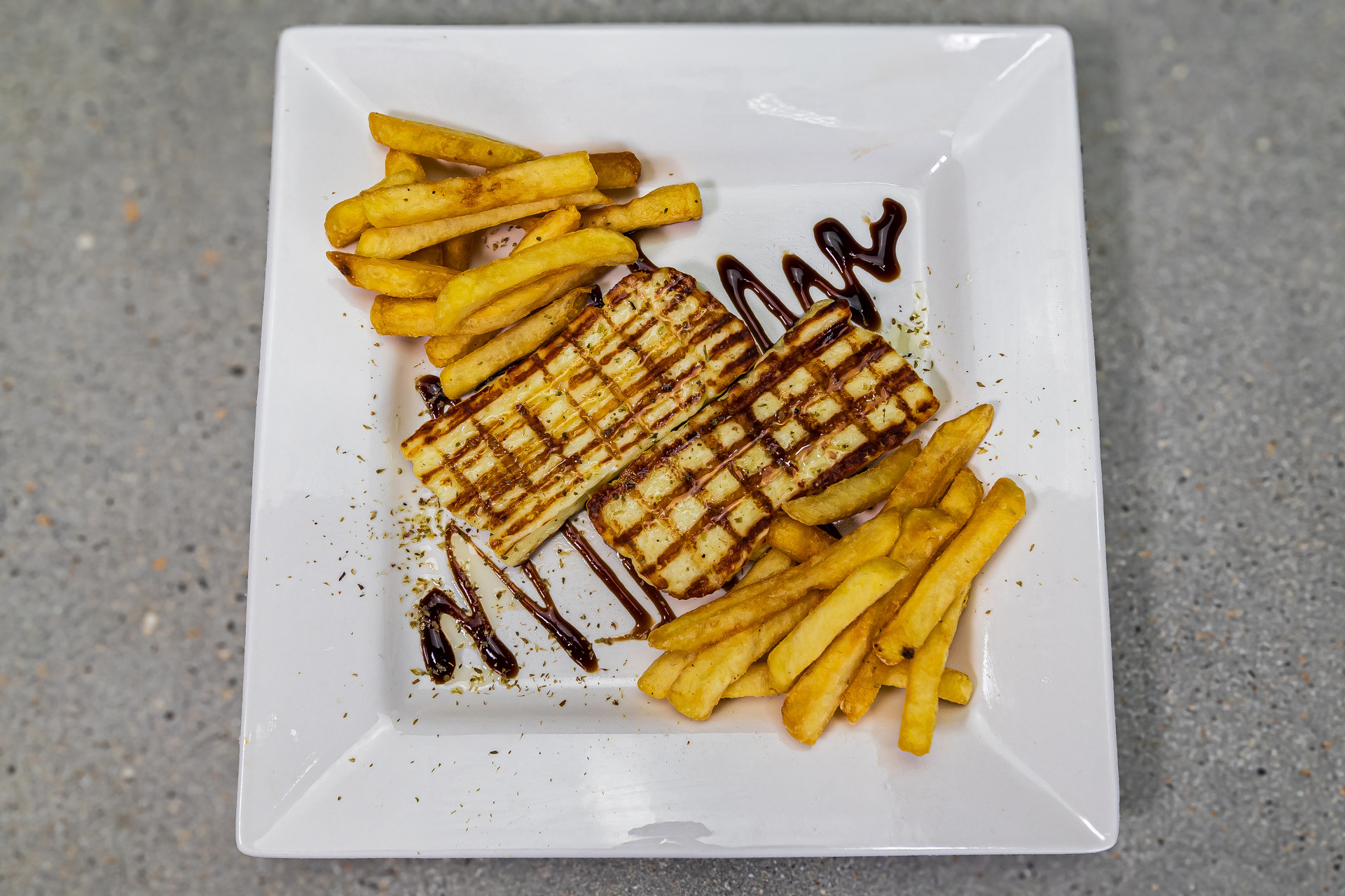 Grilled halloumi portion served with extra virgin olive oil, oregano and french fries – Cristina's Greek Souvlaki Daventry